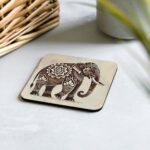 Elephant Mandala Cork-back Coaster protecting coffee table
