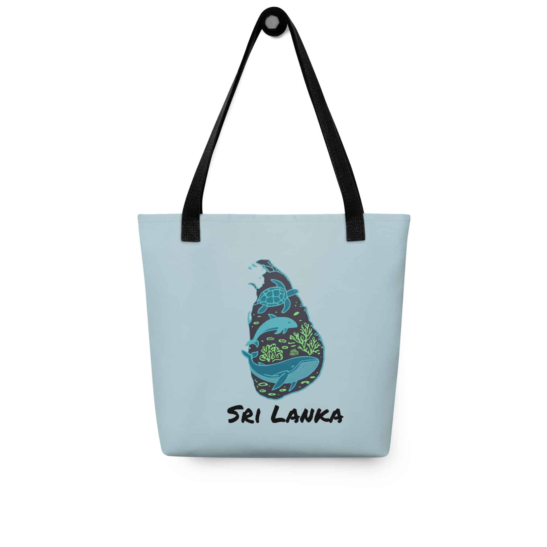 Woman carrying the stylish deep blue Sri Lanka Tote Bag over her shoulder on a sunny day.