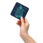 A hand holding the square Midnight Kingfisher Coaster, highlighting its size and teal artwork.