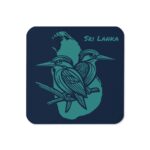 A Midnight Kingfisher Coaster with a stylised two-bird design on a dark navy surface.