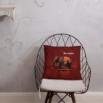 The Cinnamon Tusker Pillow displayed as a bold accent cushion on a cosy reading armchair.