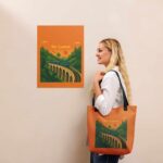 A stylish person carrying the Nine Arches Whistle Tote Bag, an example of premium Sri Lankan Merch.