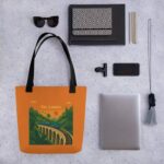 Angled shot of the Nine Arches Whistle Tote Bag showcasing its durable polyester fabric.